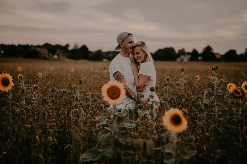 Pärchen hinter Sonnenblumen